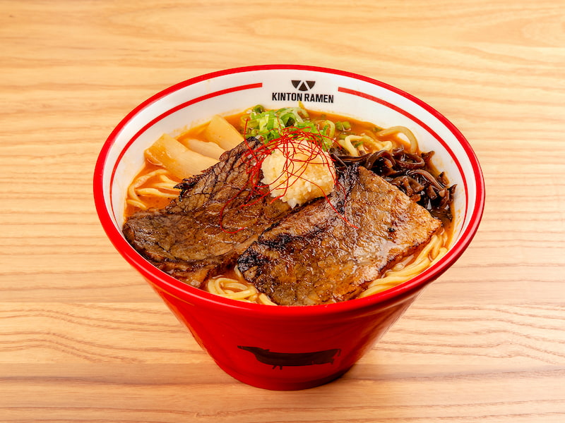 A flavorful bowl of Beef Spicy Garlic ramen, featuring tender beef, a rich garlic-infused broth, and fresh toppings, served at Kinton Ramen