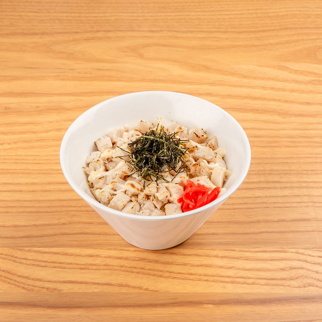 A serving of beef donburi, featuring chopped chicken breast over rice, garnished with KINTON original sauce, honey, mayo, shredded nori, red ginger, scallions, served at Kinton Ramen