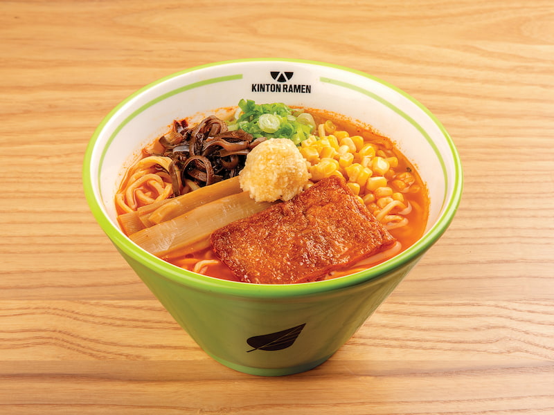 A bowl of Spicy Garlic Veggie ramen, featuring fresh vegetables, rich broth, and aromatic herbs, served at Kinton Ramen for a flavourful meal.