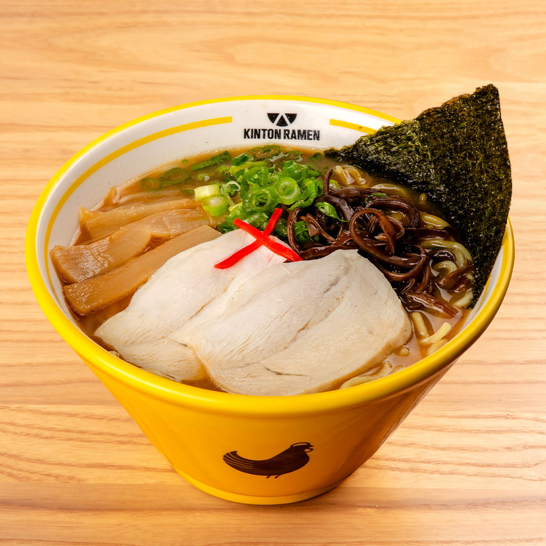 A bowl of Chicken Shoyu ramen topped with nori, showcasing rich broth, tender chicken, and fresh garnishes, served at Kinton Ramen.