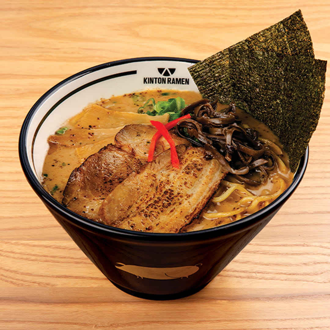 A bowl of Pork Shoyu ramen, featuring tender pork slices, savory broth, nori, and fresh toppings, served at Kinton Ramen