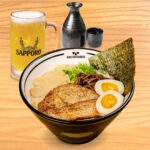 A refreshing Beer or Sake combo, featuring a glass of beer or a cup of sake, served as a perfect pairing at Kinton Ramen