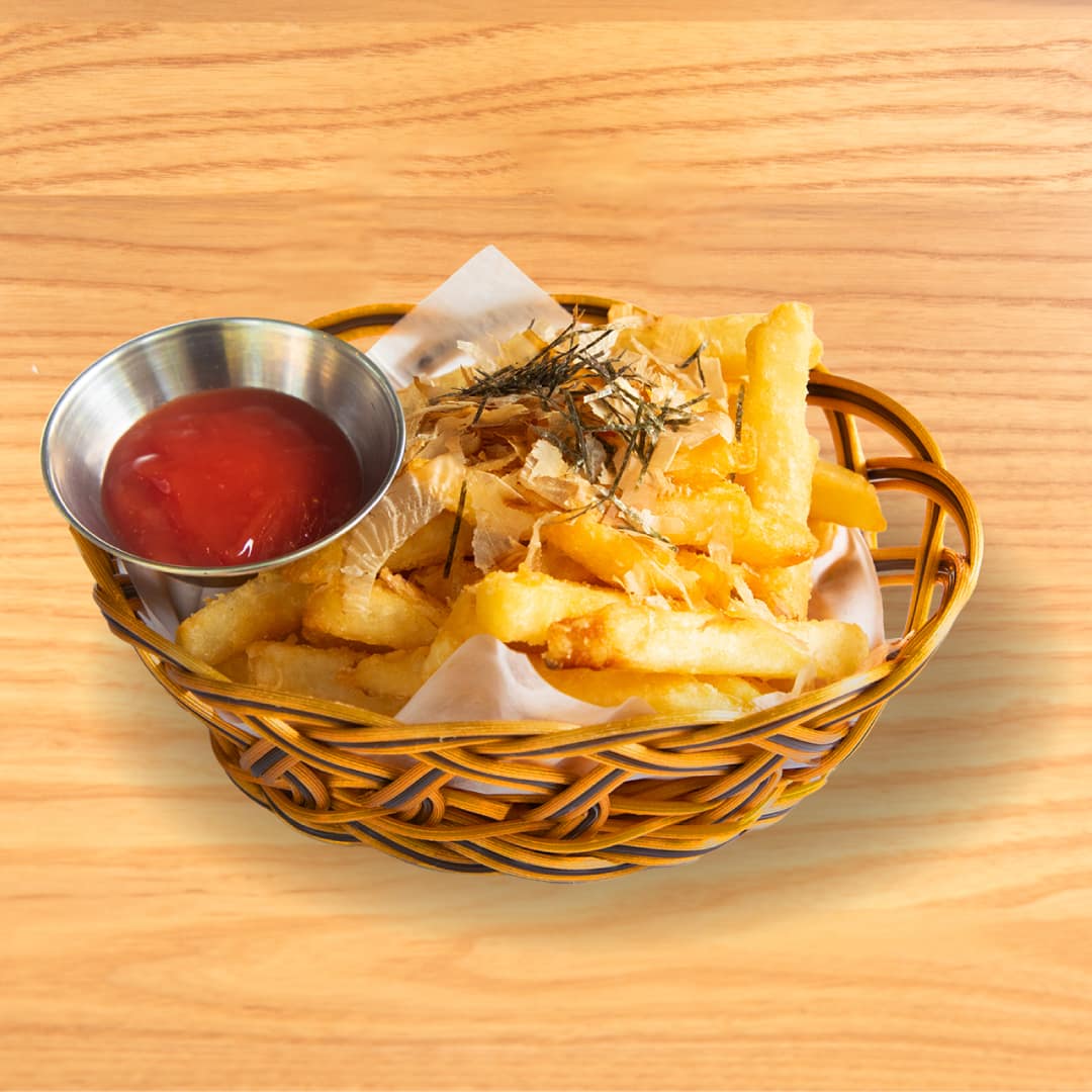 Crispy Tokyo fries served with a side of ketchup, showcasing a delicious and popular side dish at Kinton Ramen.